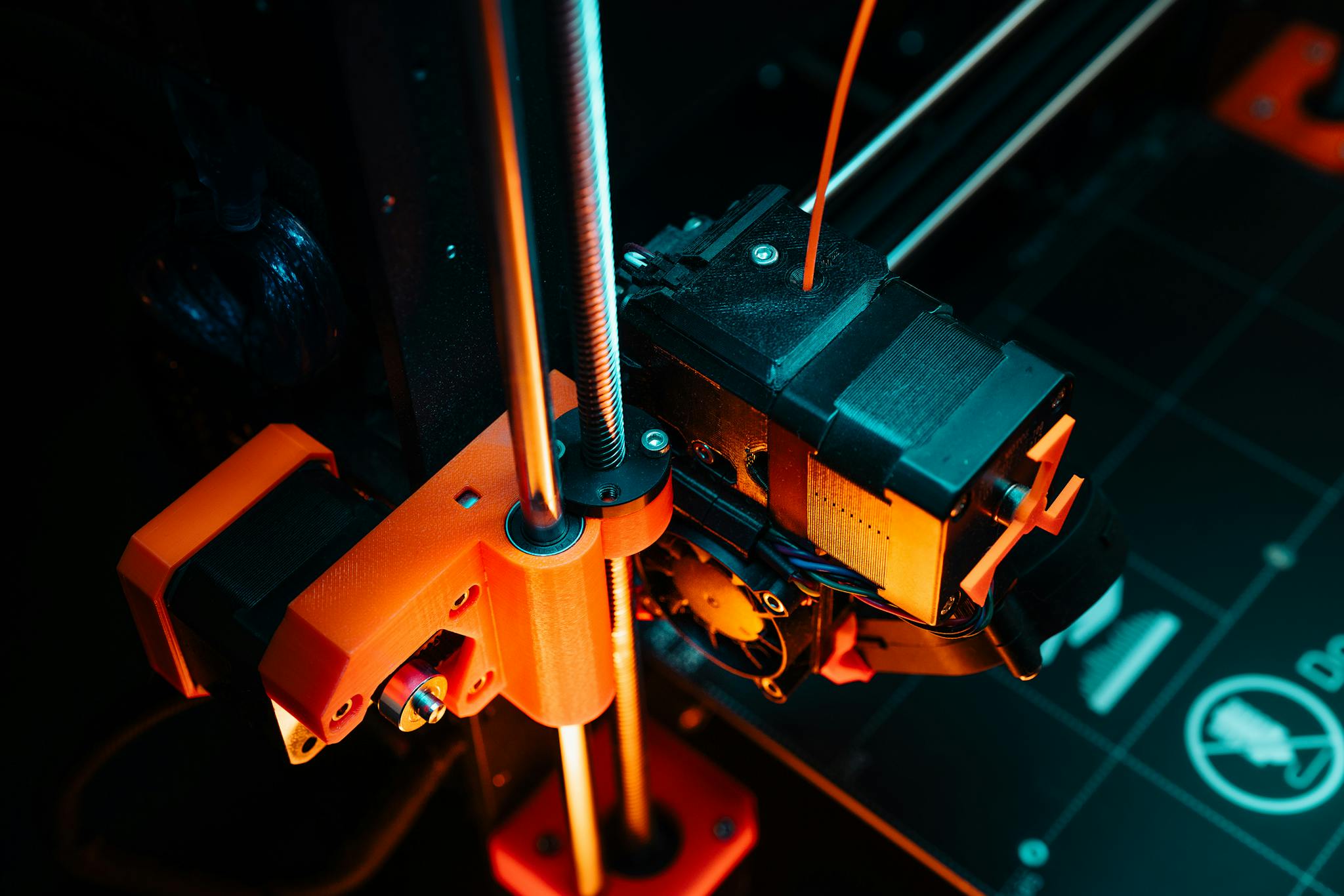 A colorful close-up of a 3D printer operating, showcasing mechanical precision and technology.